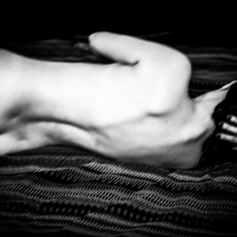Black and white fine art photograph focusing on the human body and touch by Eleni Onasoglou.