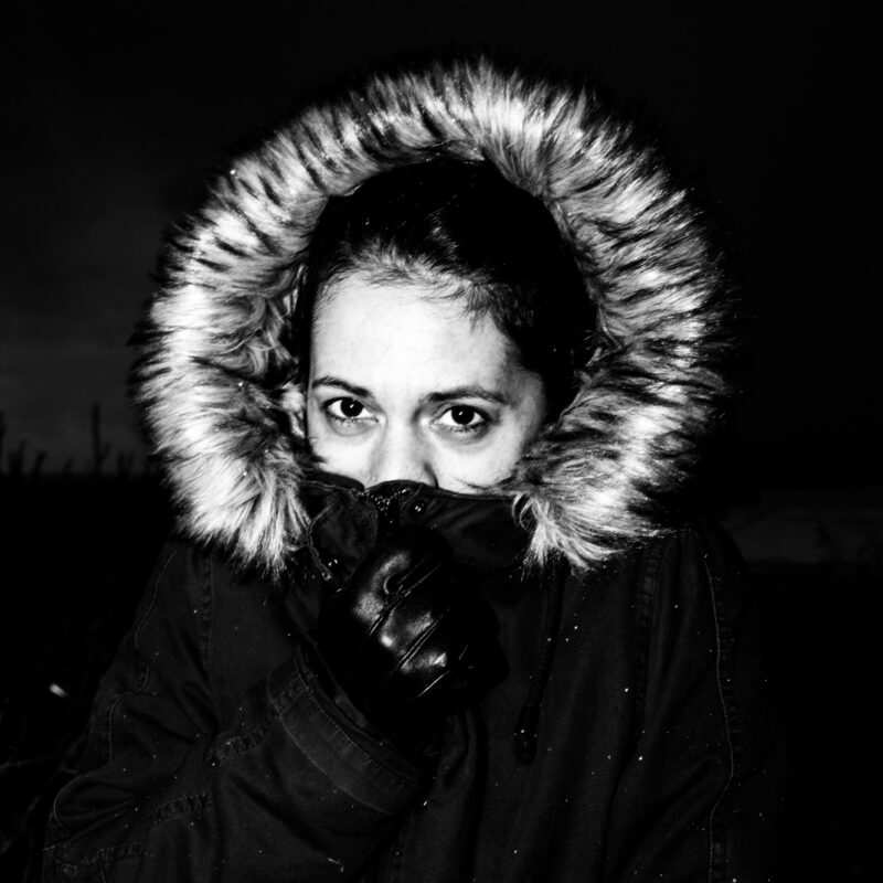 Black and white fine art photograph of a woman in the snow by Eleni Onasoglou.